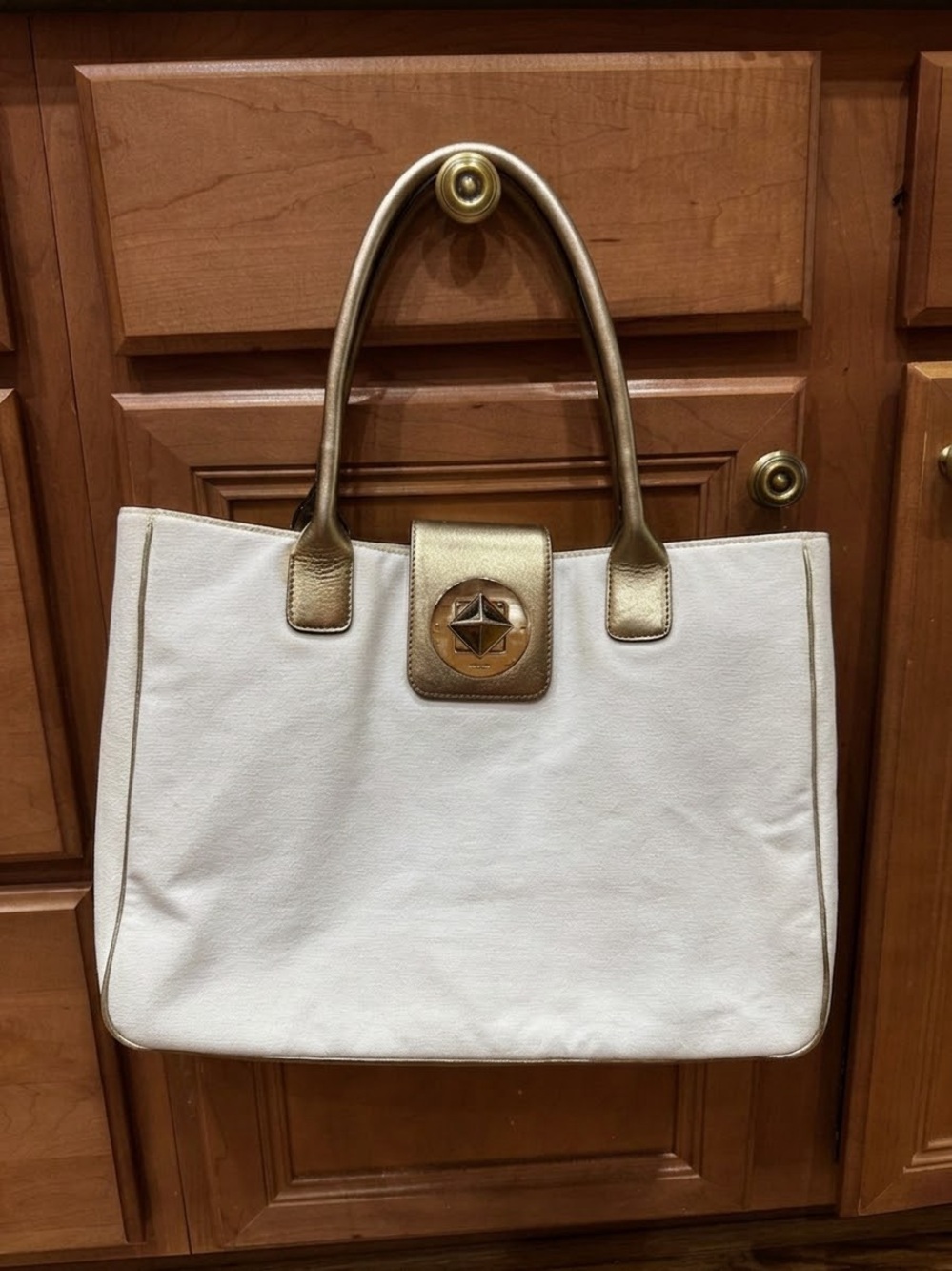 kate spade Gold and White Tote with Pyramid Lock